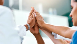 Shot of doctors in a hospitalCloseup shot of a group of medical practitioners high fiving in a hospital